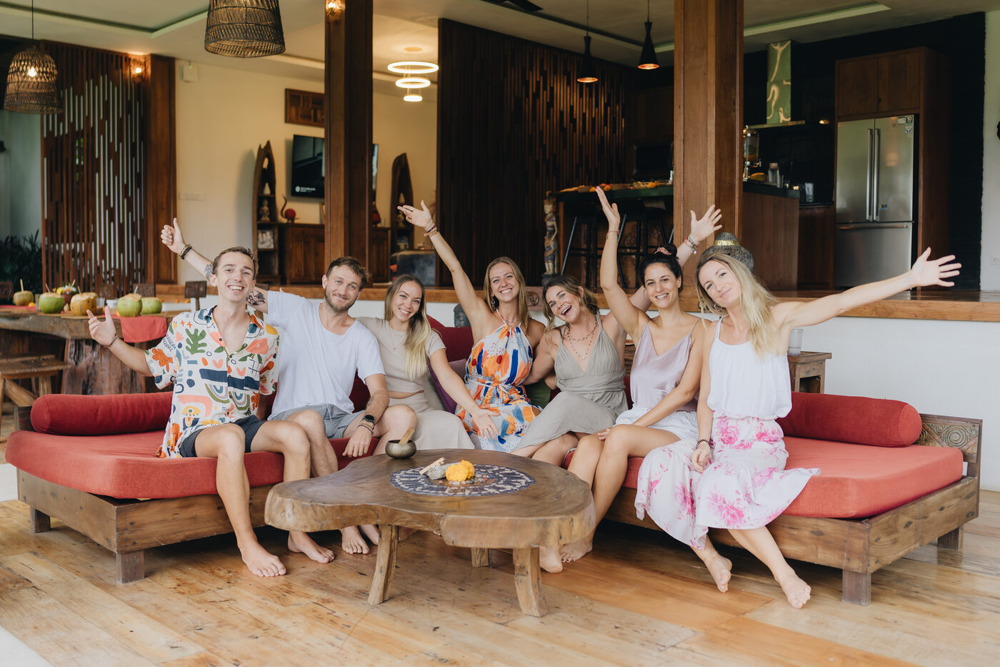 A group of retreat guests laughing together in a Bali lounge