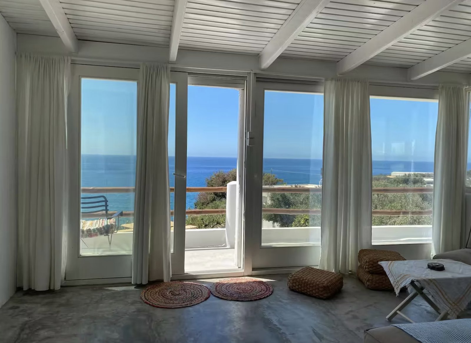 Panoramic view over Ferma Bay from a room with floor-to-ceiling windows