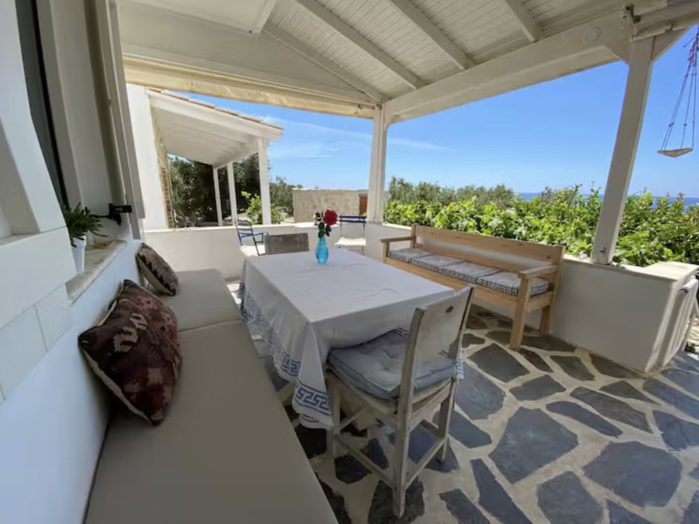 Shaded outdoor dining terrace with sea view